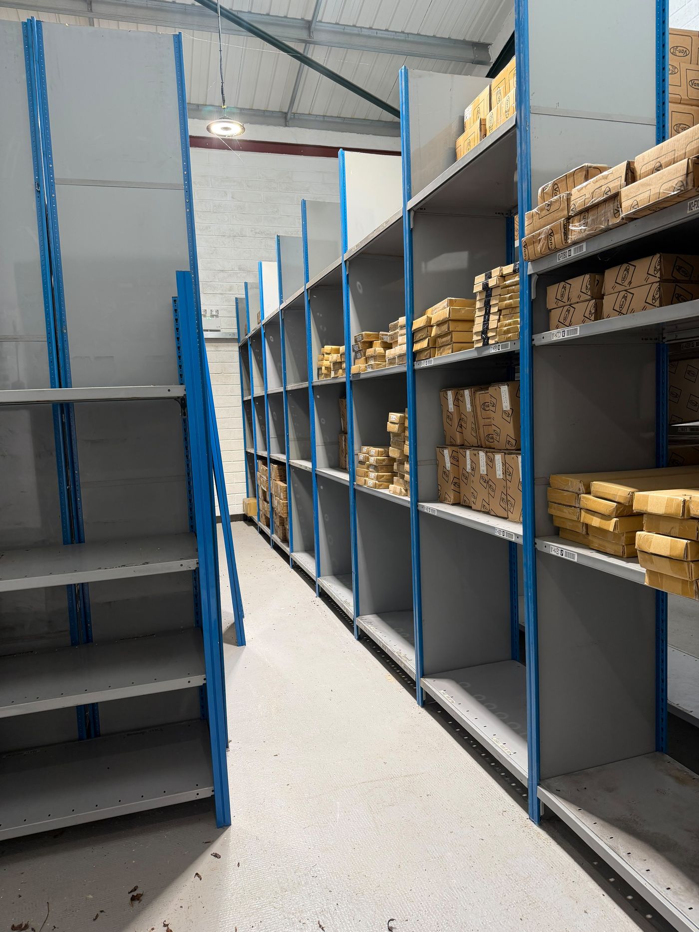 Industrial storage shelving inside the warehouse with boxed stock on upper levels