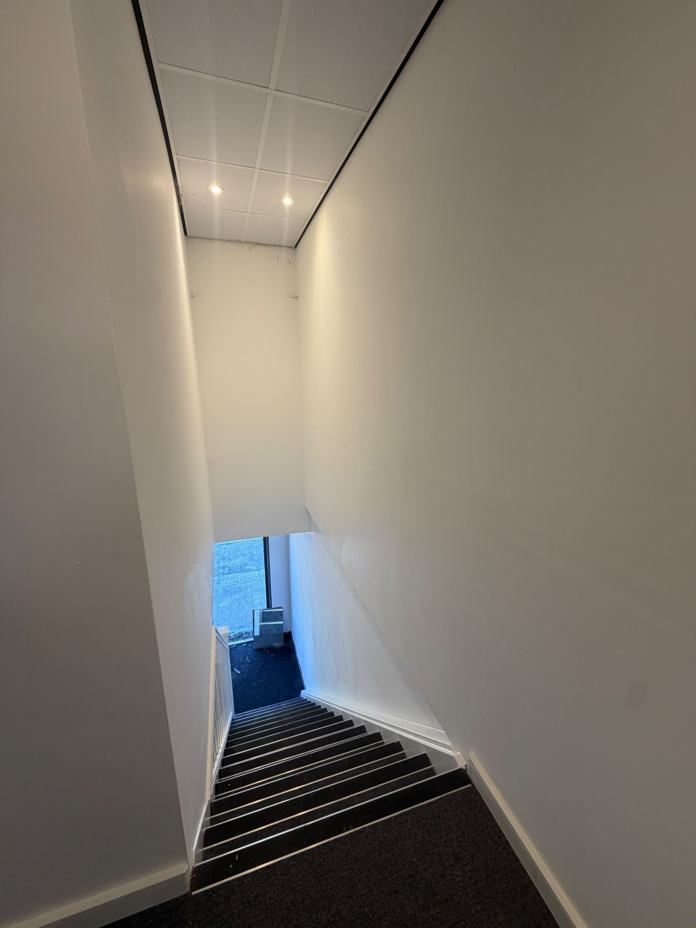 Carpeted internal staircase leading to the first-floor office