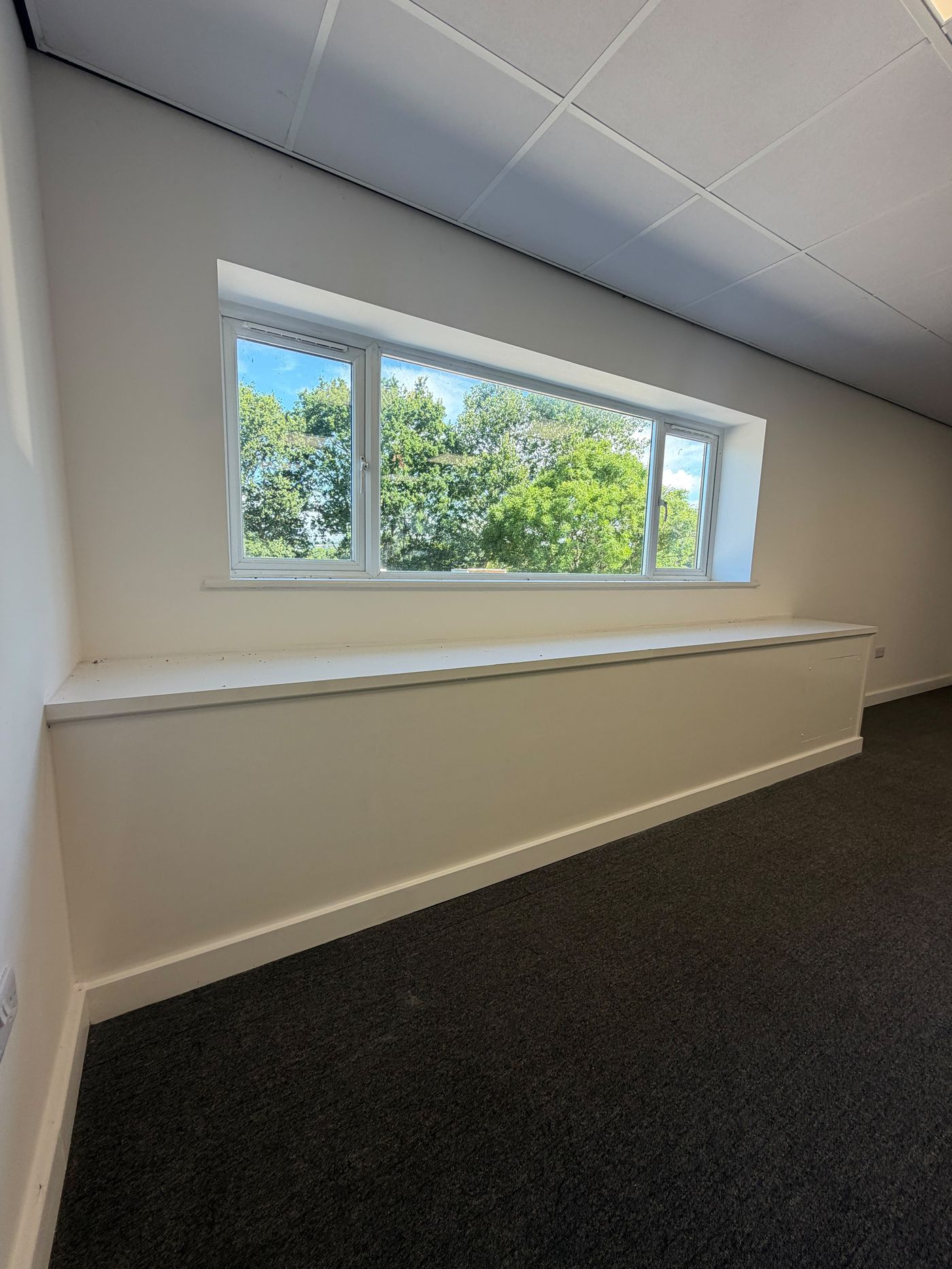 First-floor office window with views over Somerset countryside and mature trees