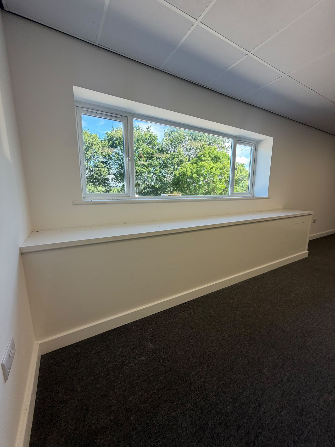 Bright first-floor office interior with large window and countryside views