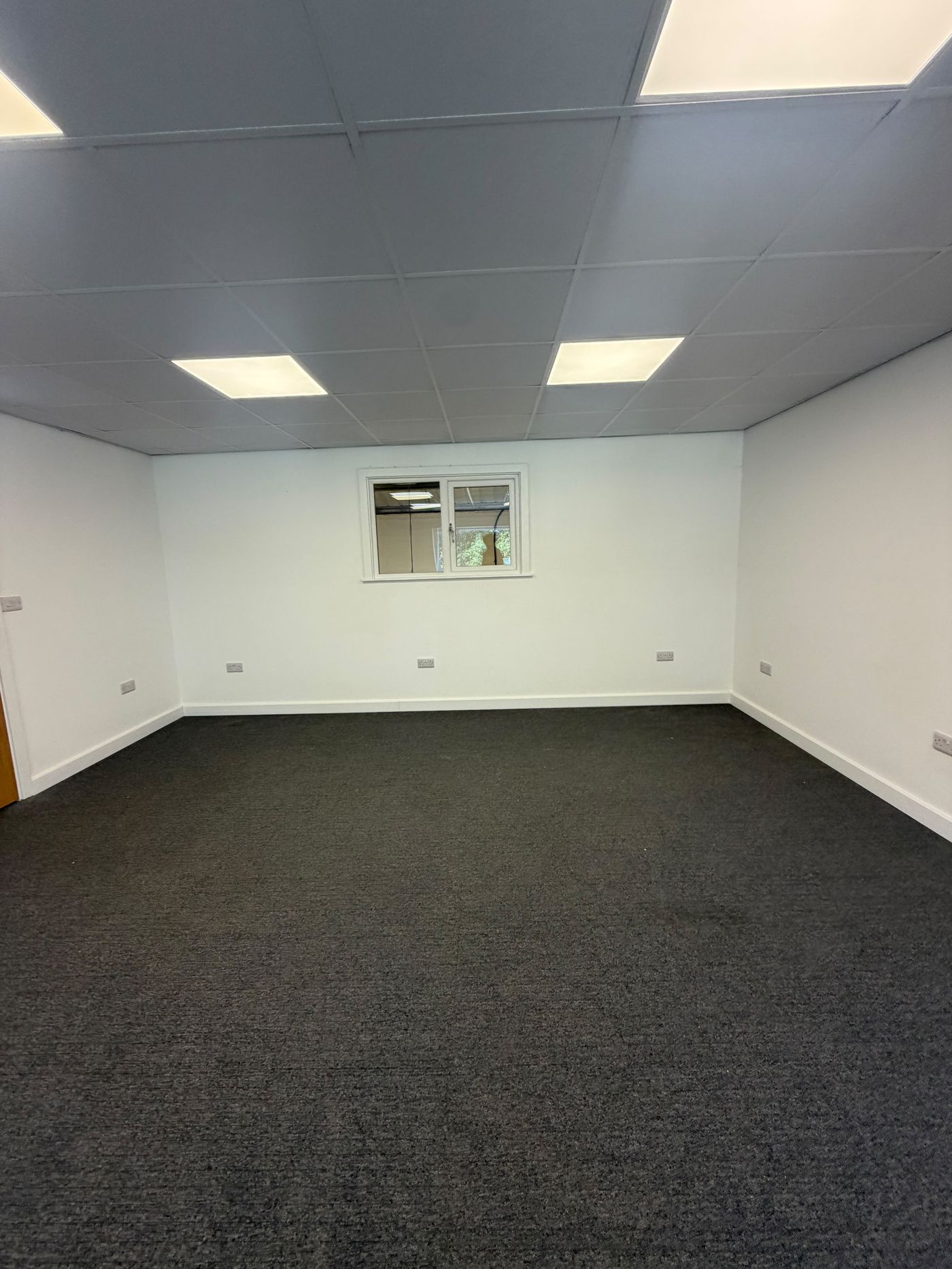Vacant first-floor office space with suspended ceiling and power points throughout