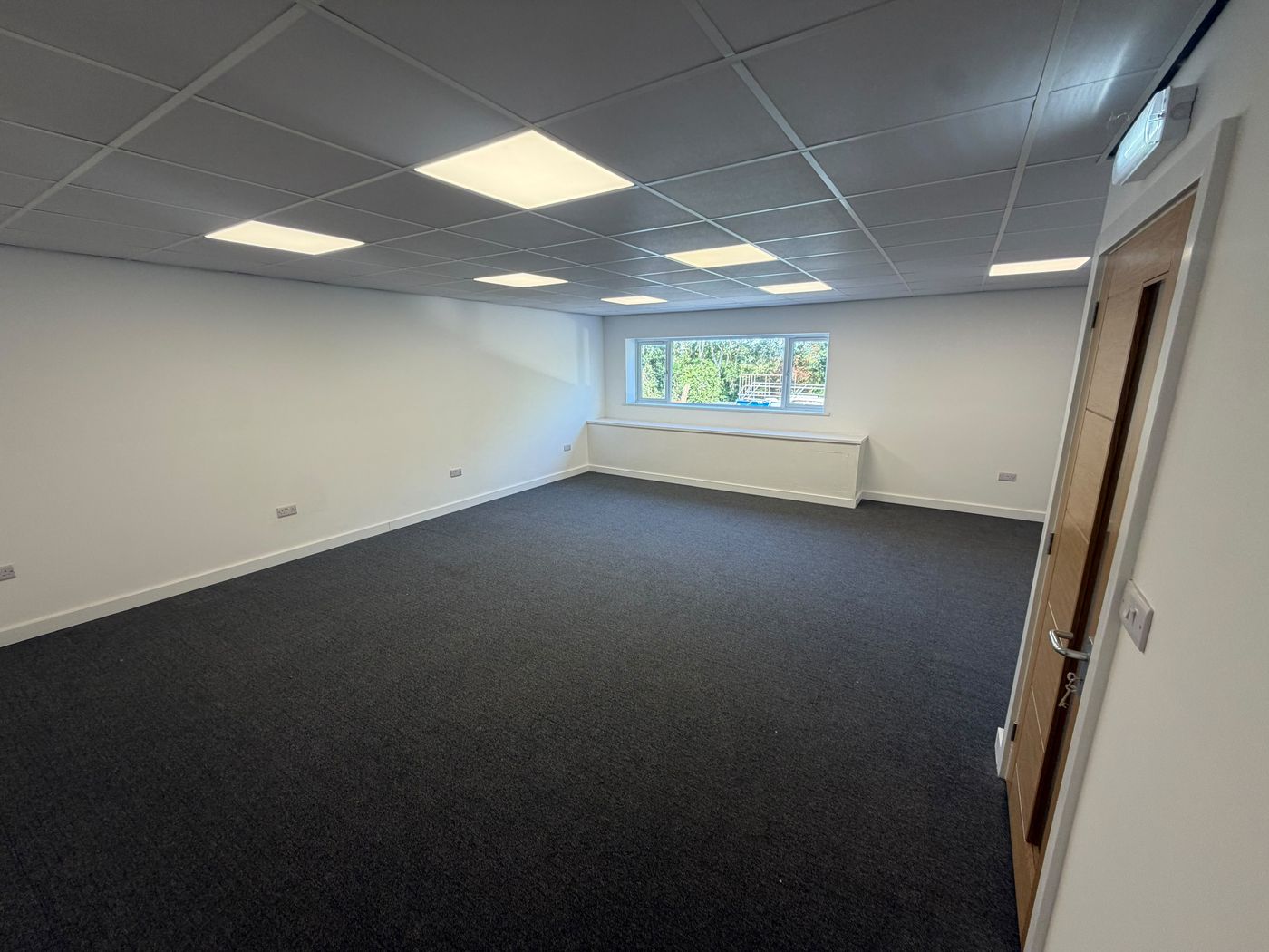 Bright first-floor office with woodland views through the side window